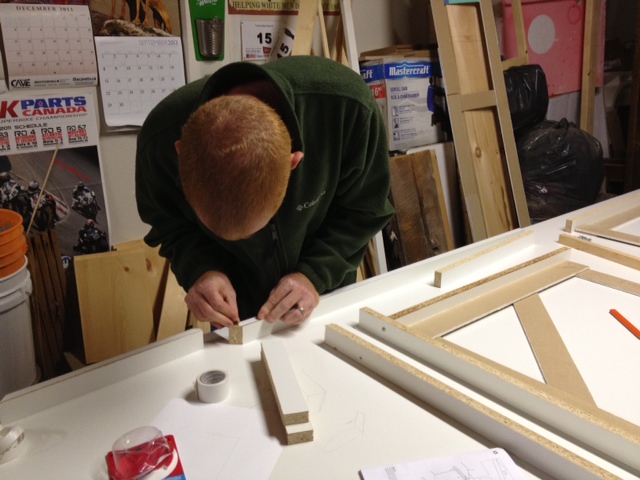 Jeremy applying double sided tape to one of the form sides.