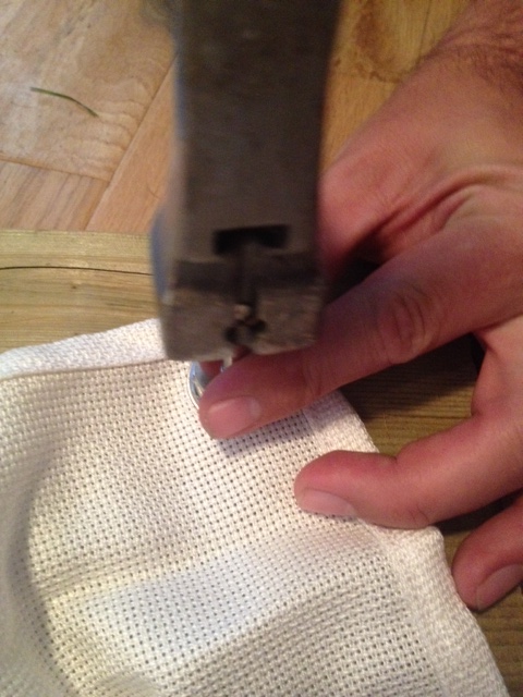 Installing the grommets. Hammering the grommet tool and securing the grommets.